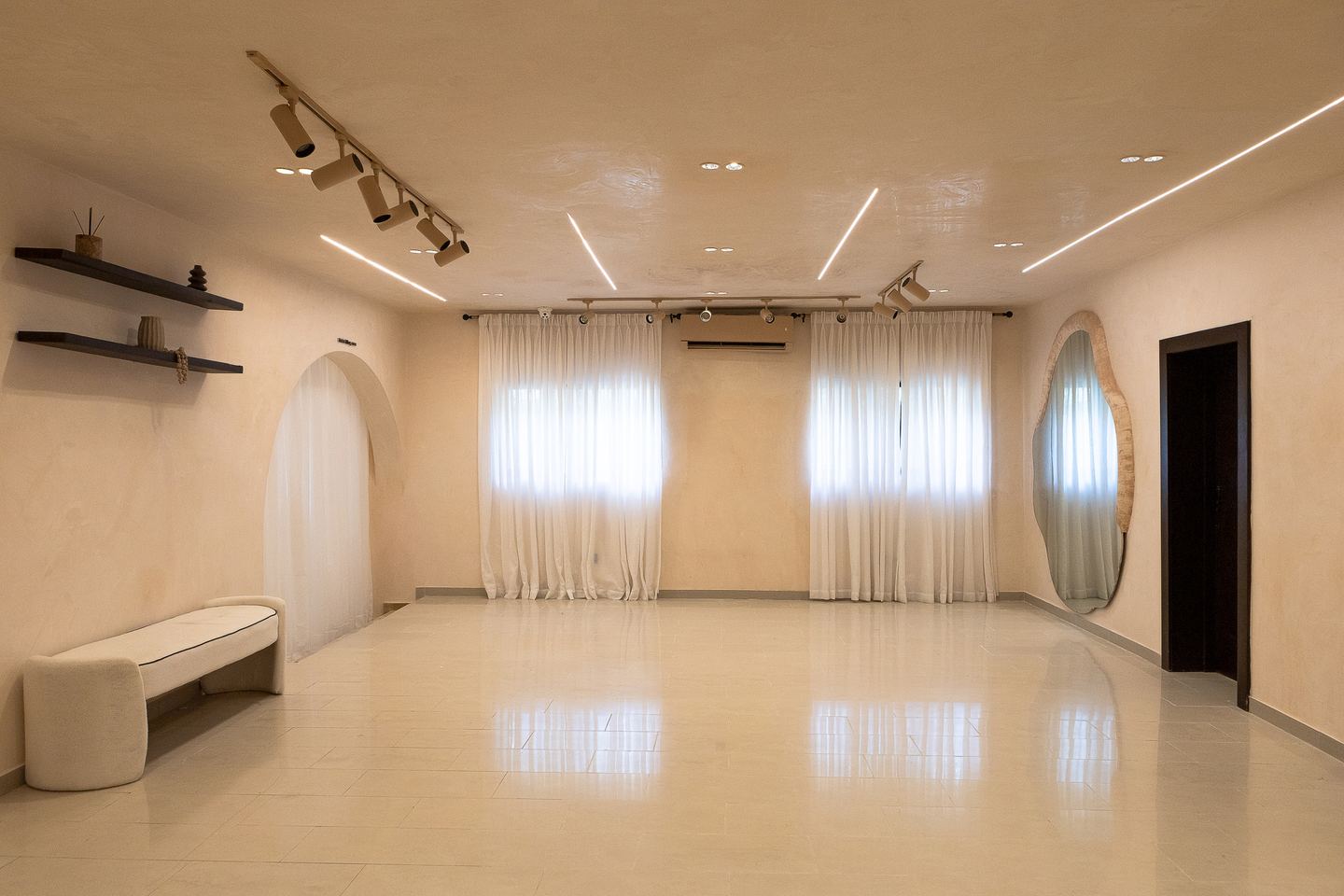 Emagine showroom framed by soft curtains and sculptural arches
