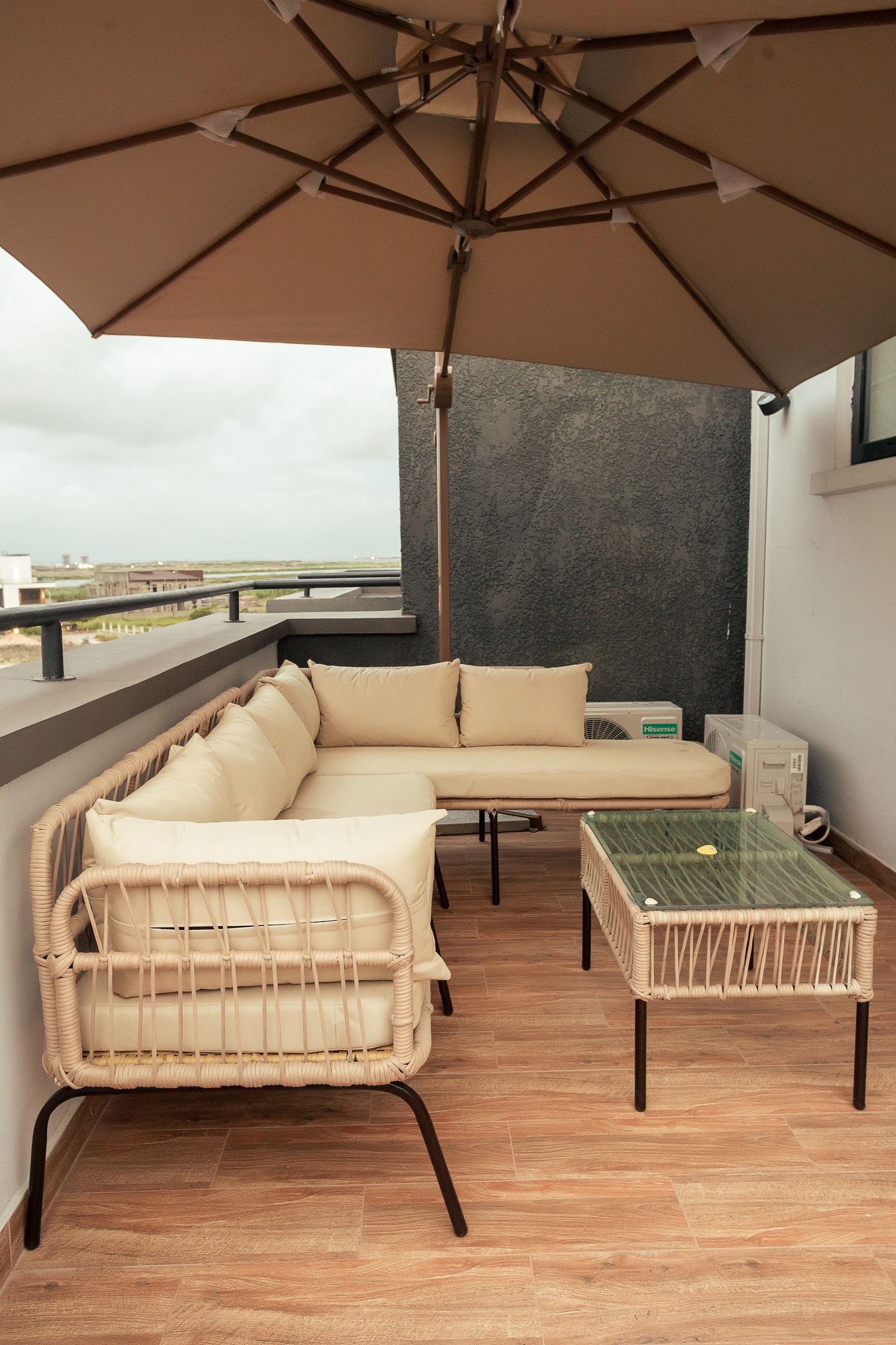 The terrace under its parasol, looking out over the city