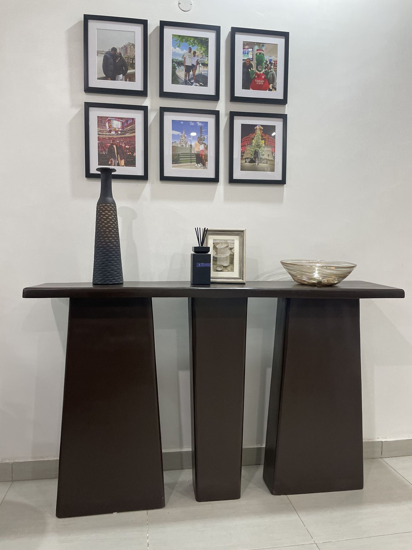Slim timber console styled with art, books and sculptural objects