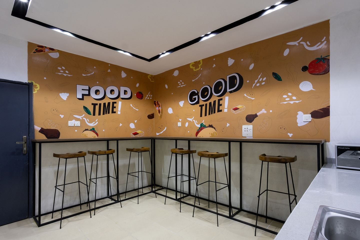 Novac break area with playful food graphics and bar seating