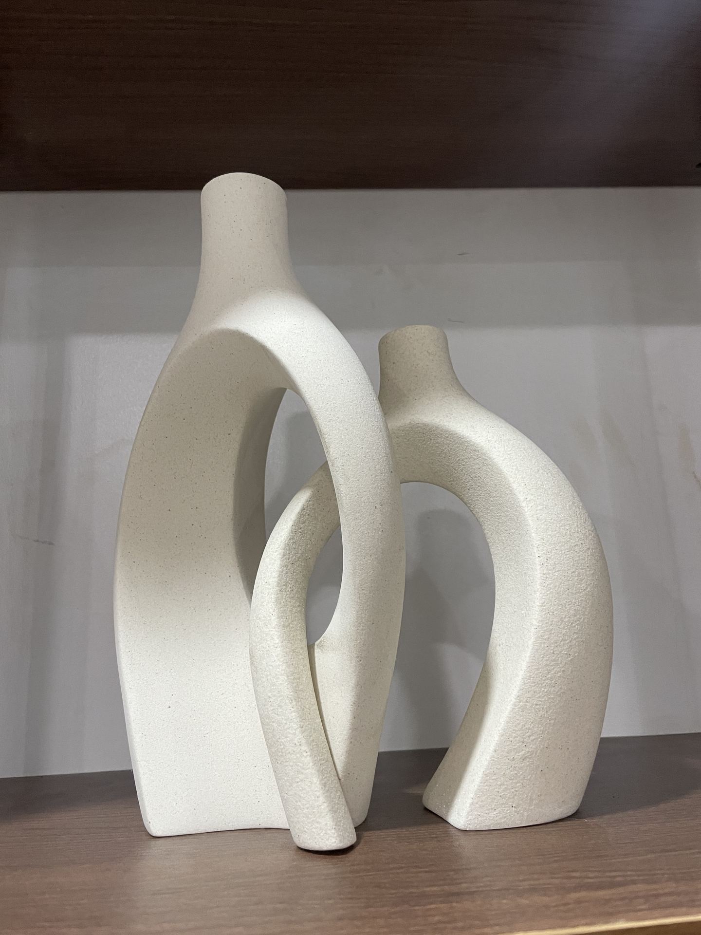 Close view of interlocking white ceramic sculptures