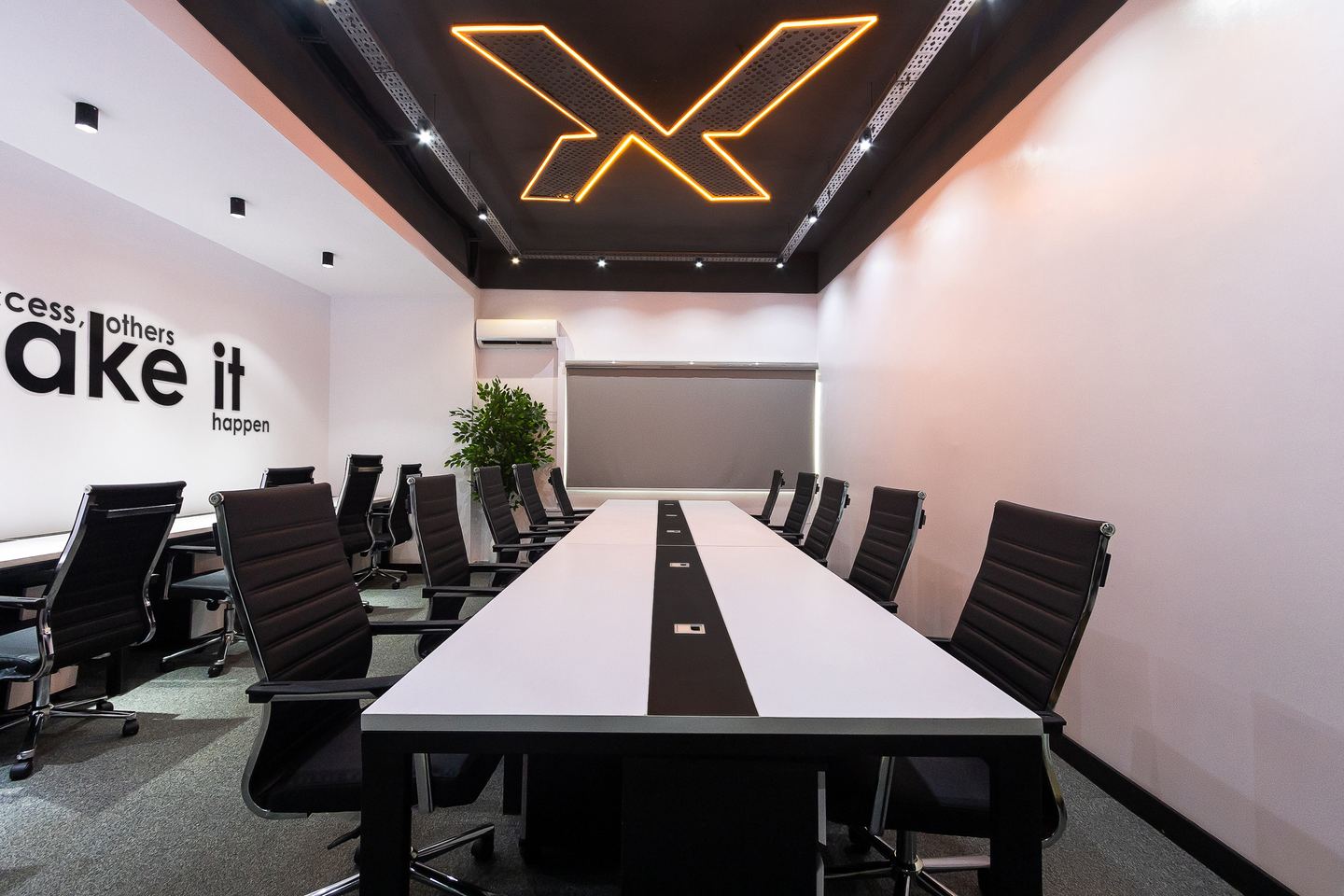 The main boardroom, lit by the company's mark cut into the ceiling