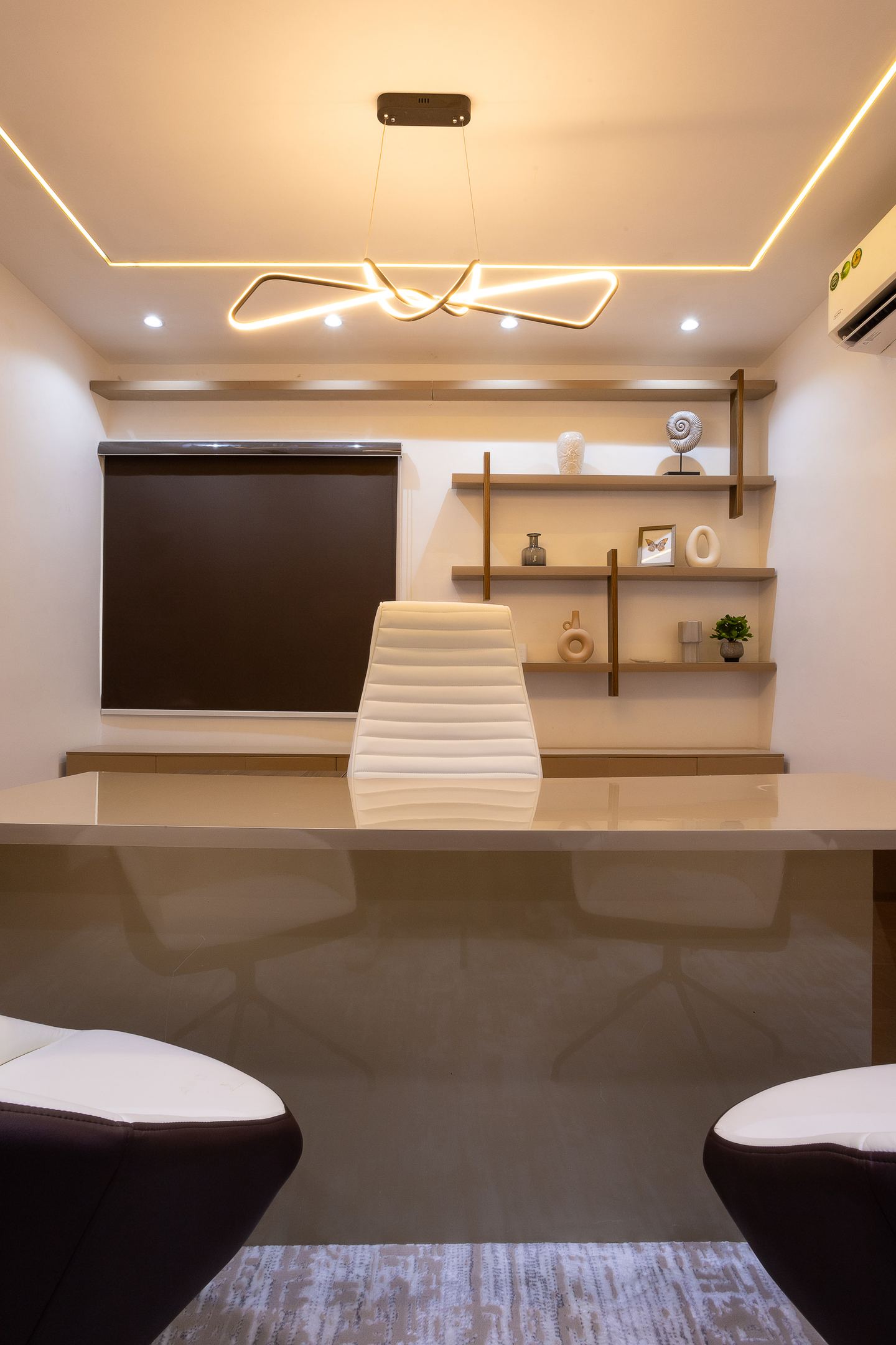 Executive office at Novac with sculptural lighting and display shelving