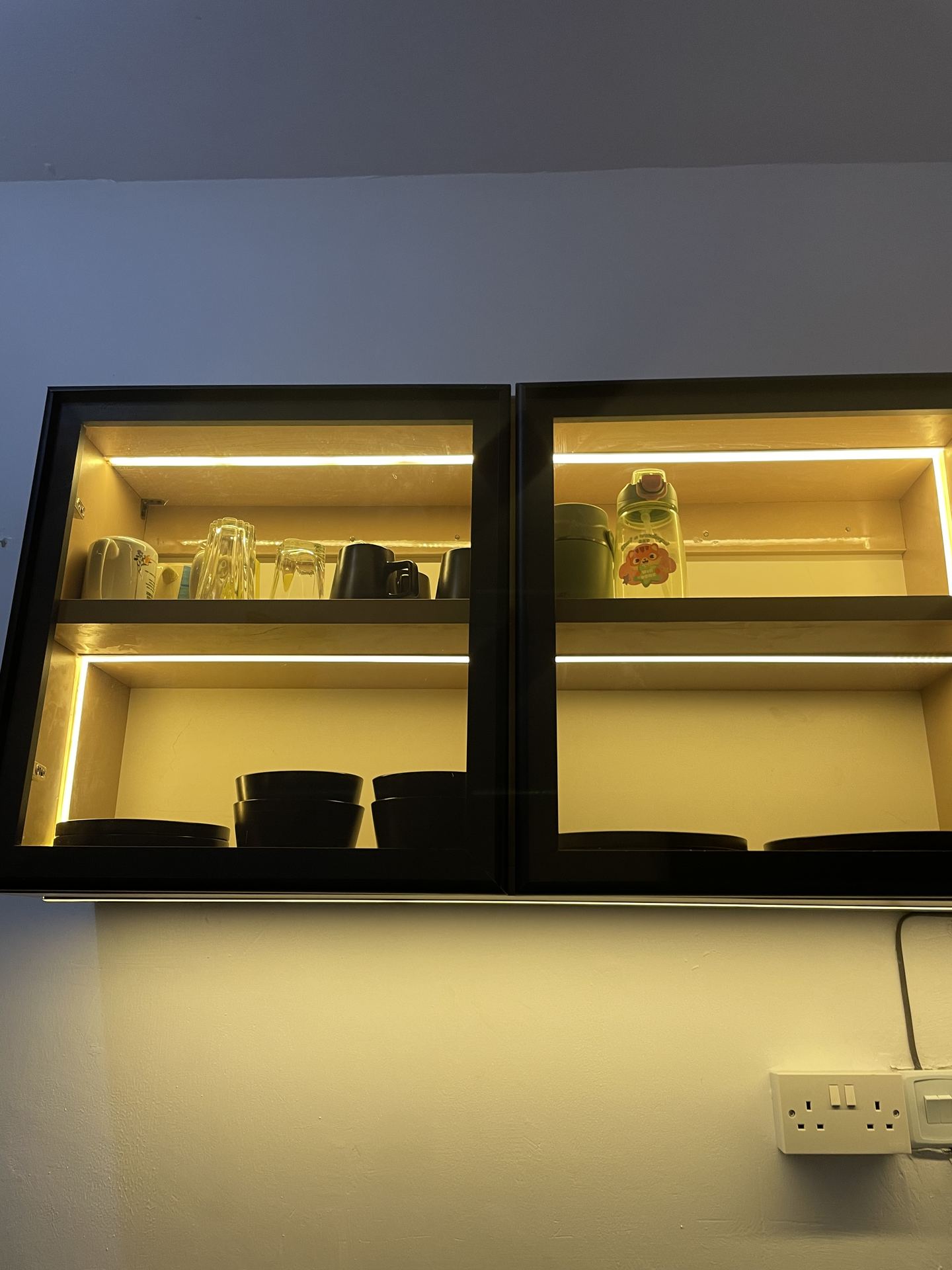 Wide view along the galley kitchen with illuminated cabinetry