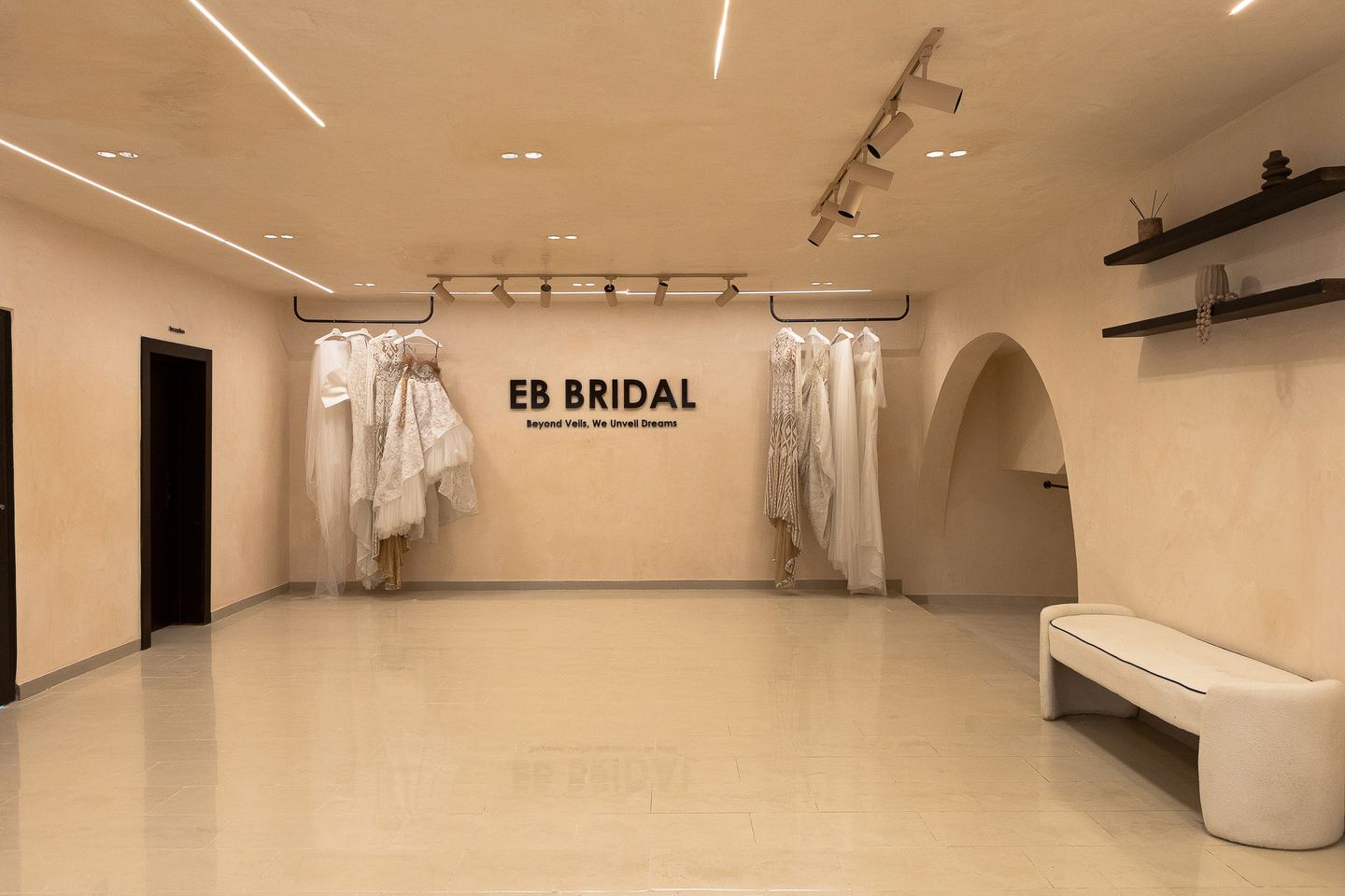 Wide view of the Emagine bridal showroom with display rails and arched alcoves
