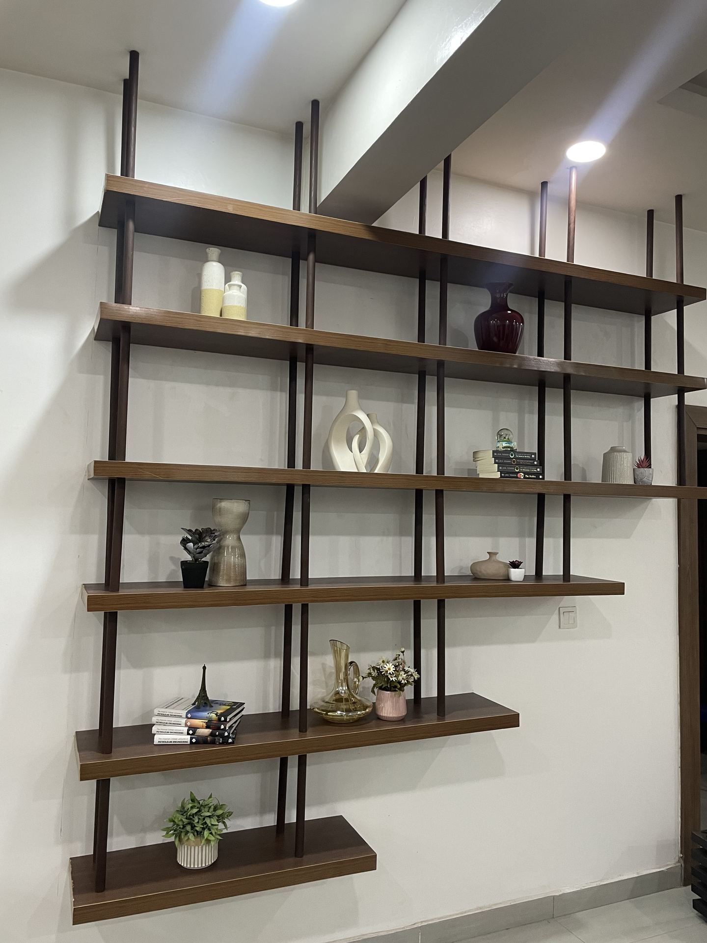 Timber-and-black-metal display shelving with curated objects