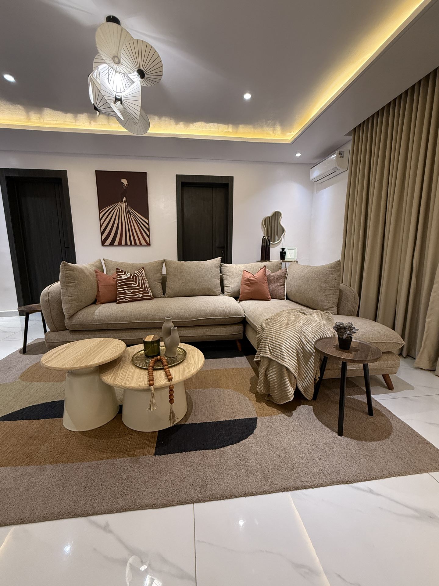 Majoro living room with curved sofa, timber tables and pendant light